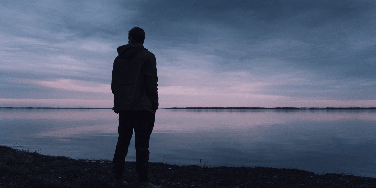 Single Silhouette in front of sunset on water