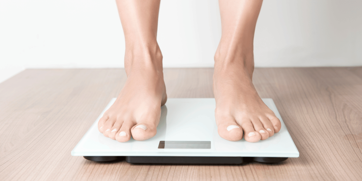 feet standing on a weight scale